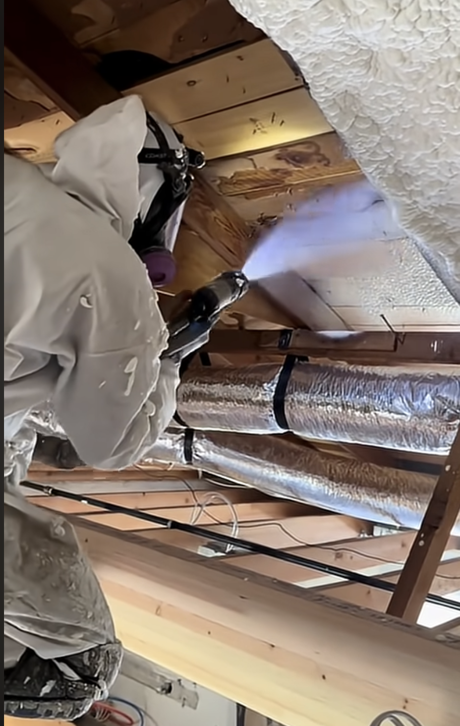 Insulation contractor working near ductwork in a home attic in Surprise, AZ