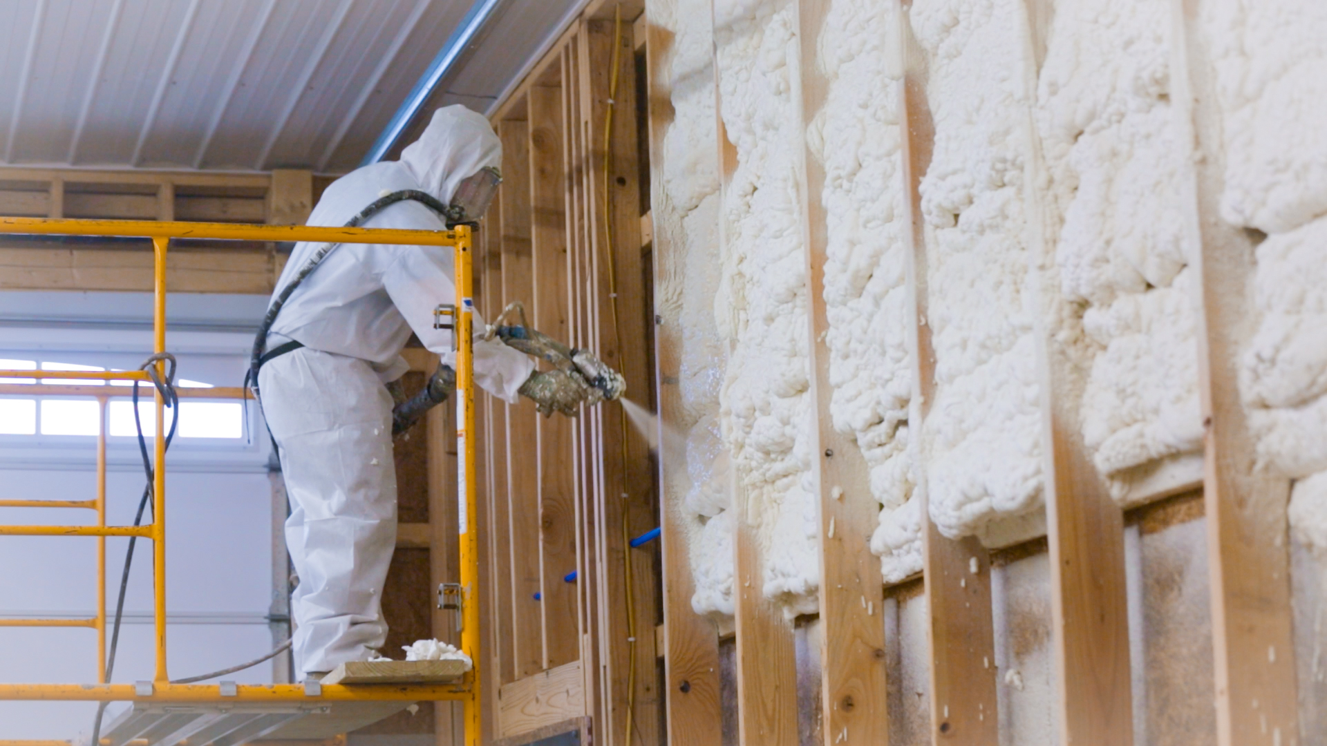 Spray foam insulation being applied inside a metal building in Surprise, AZ